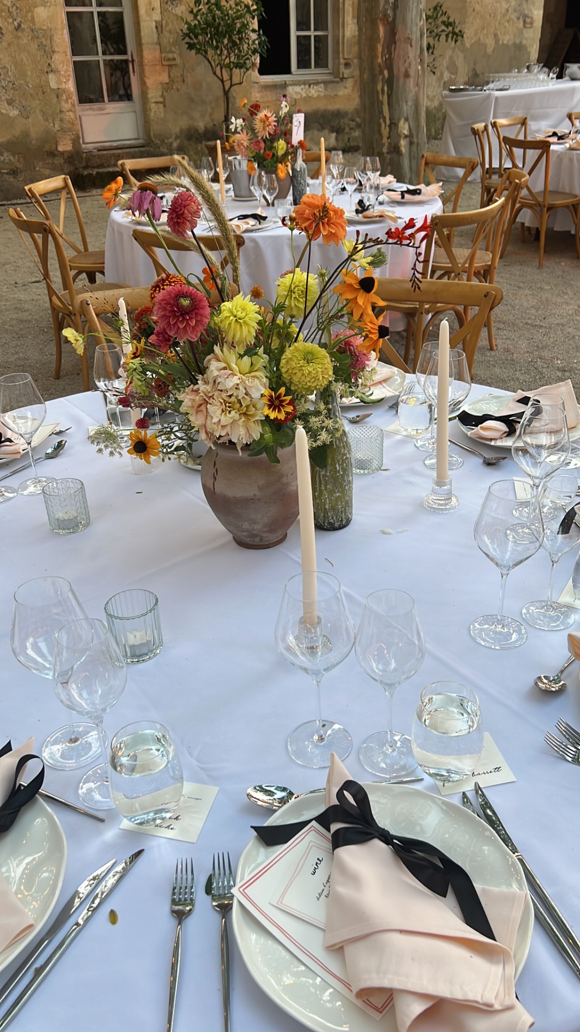Colourful wedding reception table with flowers and candles
