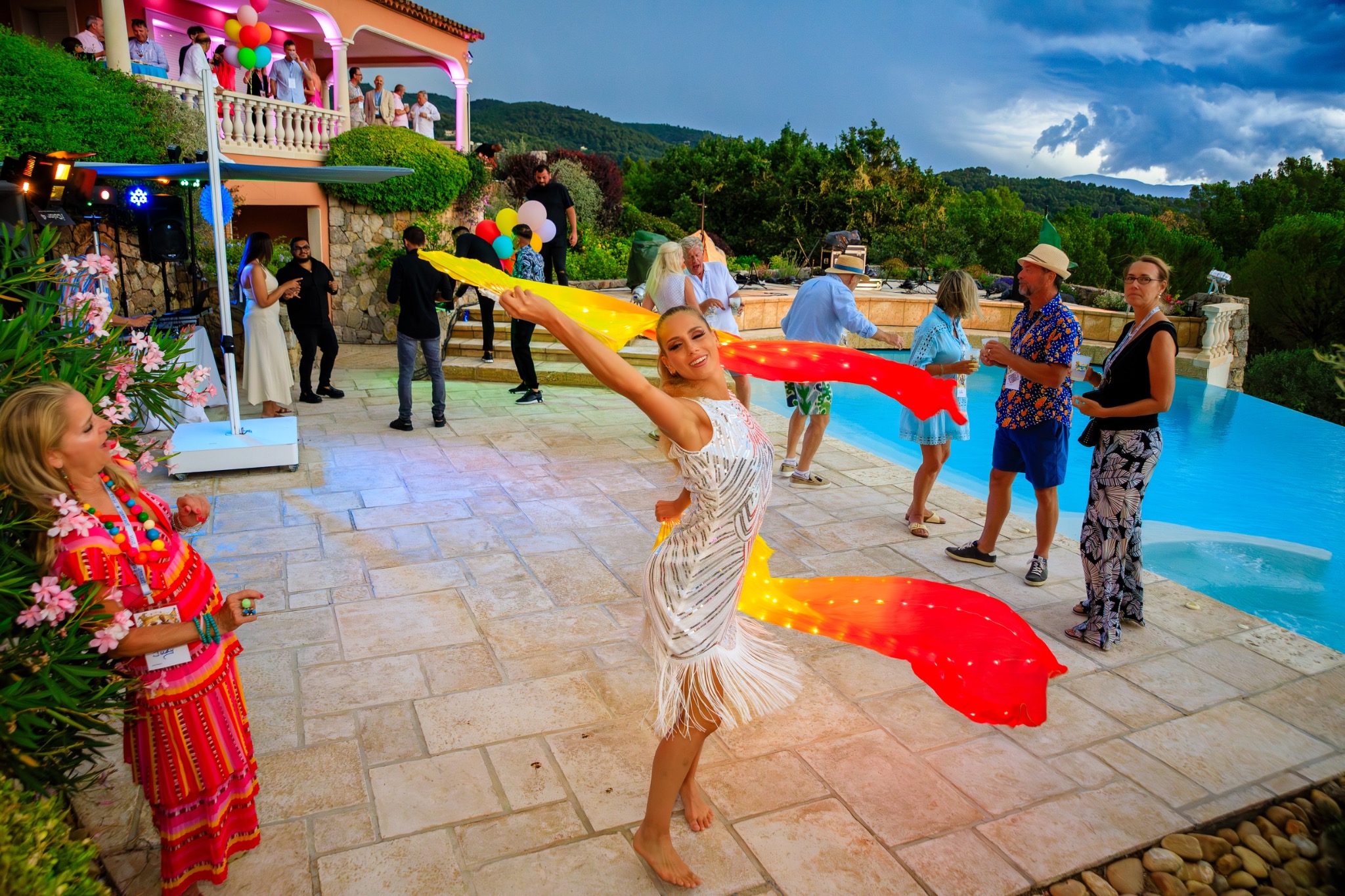 Performers entertaining guests beside the pool