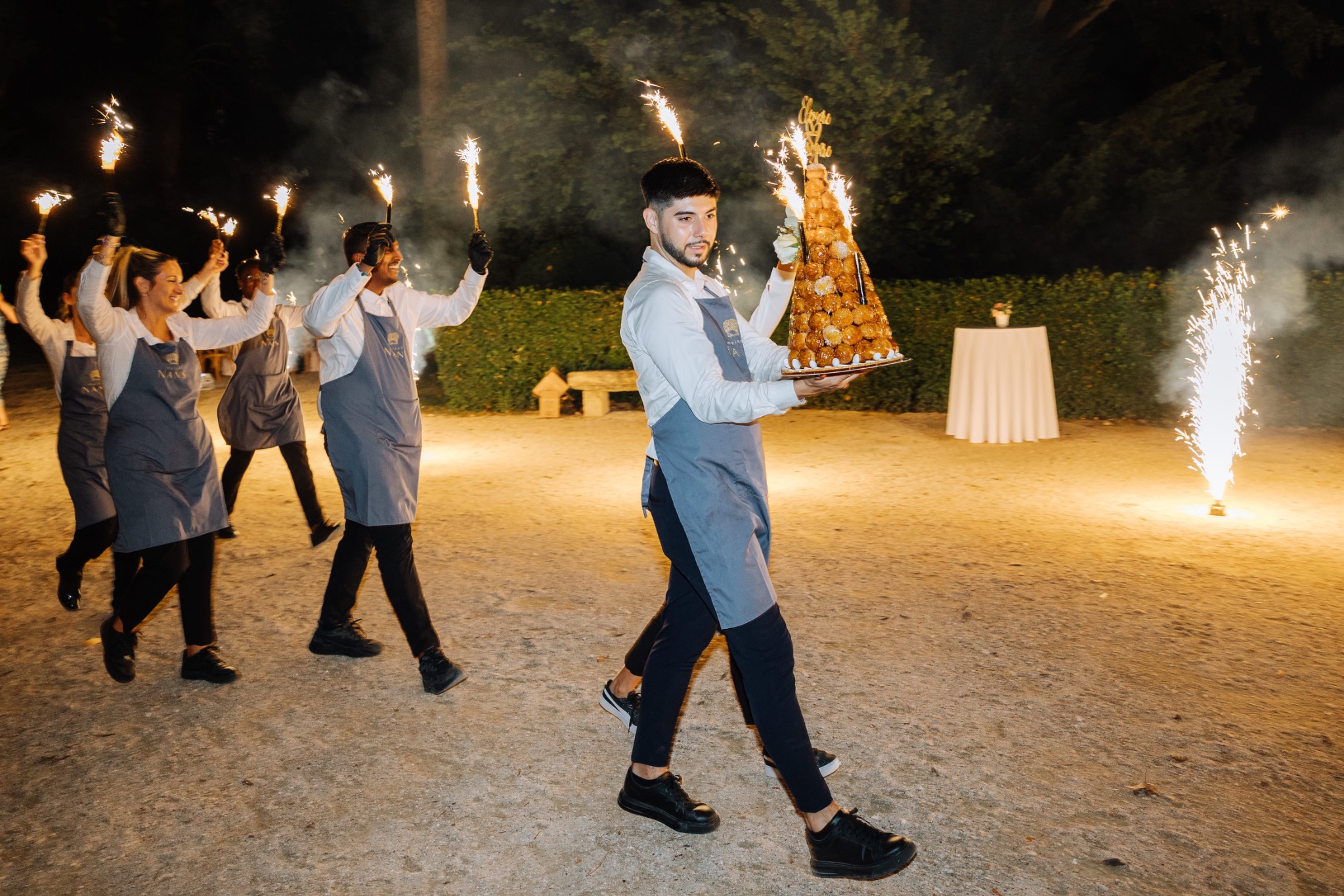 Guests dancing at night beneath sparkling lights